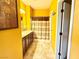Bathroom features dual sinks, brown cabinets, and a shower with a brown and beige shower curtain at 8477 Orly Ave, Las Vegas, NV 89143