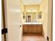 Bathroom features a vanity with wood cabinets, a single sink, and a large mirror at 8477 Orly Ave, Las Vegas, NV 89143