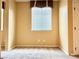Small empty bedroom with neutral carpet and trim and window with blinds at 8477 Orly Ave, Las Vegas, NV 89143