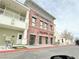 Attractive two-story commercial building with brick accents, professional signage, and street-side benches at 8477 Orly Ave, Las Vegas, NV 89143