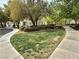 Green common area with walking path, trees, and landscaping, enhancing community appeal at 8477 Orly Ave, Las Vegas, NV 89143