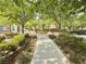 Landscaped common area with walking path, trees, and benches, creating a serene environment at 8477 Orly Ave, Las Vegas, NV 89143