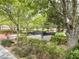 Relaxing common area featuring benches and surrounded by green trees and well-maintained landscaping at 8477 Orly Ave, Las Vegas, NV 89143
