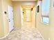 Inviting hallway featuring ceramic tile floors, neutral paint, and an arched entryway at 8477 Orly Ave, Las Vegas, NV 89143