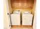 Laundry room features a white washer and dryer with wood cabinets above at 8477 Orly Ave, Las Vegas, NV 89143