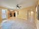 Spacious living room open to kitchen featuring modern ceiling fan and natural light at 8477 Orly Ave, Las Vegas, NV 89143