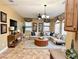 Spacious living room with neutral color palette, large sectional sofa, and decorative window treatments at 8477 Orly Ave, Las Vegas, NV 89143