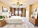 Cozy primary bedroom features a large bed, stylish furnishings, and soft, natural lighting at 8477 Orly Ave, Las Vegas, NV 89143