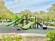 Community playground with multiple green slides and climbing structures, providing a fun and safe recreational area at 8477 Orly Ave, Las Vegas, NV 89143