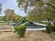 Outdoor playground with green slides and climbing structures, surrounded by shade trees at 8477 Orly Ave, Las Vegas, NV 89143