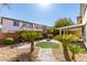 Beautiful backyard featuring a landscaped yard, stone fire pit, and covered patio at 8743 Mount Mira Loma Ave, Las Vegas, NV 89178