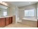 This bright bathroom features a large soaking tub, walk-in shower, and double sink vanity at 8743 Mount Mira Loma Ave, Las Vegas, NV 89178