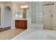 Spacious bathroom with soaking tub, shower with glass block, and a modern vanity at 8743 Mount Mira Loma Ave, Las Vegas, NV 89178