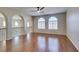 A spacious bonus room with arched doorways and wood laminate floors at 8743 Mount Mira Loma Ave, Las Vegas, NV 89178