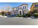 Charming two-story home featuring a three-car garage, lush landscaping, and inviting curb appeal at 8743 Mount Mira Loma Ave, Las Vegas, NV 89178