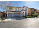 Inviting two-story home with arched windows, a three-car garage, and neatly trimmed front yard shrubs at 8743 Mount Mira Loma Ave, Las Vegas, NV 89178