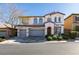Charming two-story home with arched windows, a three-car garage, and manicured landscaping at 8743 Mount Mira Loma Ave, Las Vegas, NV 89178
