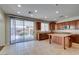 Well-lit kitchen with an island, stainless steel appliances, and a sliding door to the backyard at 8743 Mount Mira Loma Ave, Las Vegas, NV 89178
