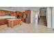 Spacious kitchen with an island, stainless steel appliances, and convenient access to the staircase at 8743 Mount Mira Loma Ave, Las Vegas, NV 89178