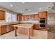 Contemporary kitchen with an island, granite countertops, and stainless steel appliances for gourmet cooking at 8743 Mount Mira Loma Ave, Las Vegas, NV 89178