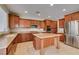 Modern kitchen with an island, granite countertops, stainless steel appliances, and ample cabinet space at 8743 Mount Mira Loma Ave, Las Vegas, NV 89178