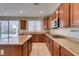 Well-equipped kitchen with an island, granite countertops, and a view of the lush backyard at 8743 Mount Mira Loma Ave, Las Vegas, NV 89178