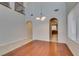 Open living area featuring hardwood floors, arched doorways, a chandelier, and ample natural light at 8743 Mount Mira Loma Ave, Las Vegas, NV 89178