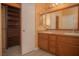 Well-lit bathroom featuring double sinks, framed mirrors, and wood cabinets at 9323 W Rochelle Ave, Las Vegas, NV 89147
