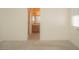 Bathroom with wood cabinets, light tile floor and a view from the bedroom at 9323 W Rochelle Ave, Las Vegas, NV 89147