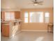 Bright dining area features a ceiling fan, tiled flooring, and a breakfast bar with granite countertops at 9323 W Rochelle Ave, Las Vegas, NV 89147