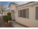 Charming single-story home featuring light stucco, inviting entryway, and decorative shutters at 9323 W Rochelle Ave, Las Vegas, NV 89147