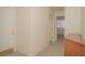 Hallway with tile floors and a small cabinet, leading to rooms with neutral carpeting and ceiling fans at 9323 W Rochelle Ave, Las Vegas, NV 89147