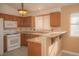 Classic kitchen featuring granite countertops, wood cabinets, and modern white appliances at 9323 W Rochelle Ave, Las Vegas, NV 89147