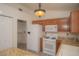 Charming kitchen featuring wood cabinets, granite countertops and modern appliances at 9323 W Rochelle Ave, Las Vegas, NV 89147