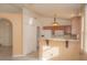 Open kitchen with wooden cabinets, a breakfast bar and white appliances at 9323 W Rochelle Ave, Las Vegas, NV 89147