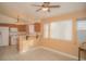 An inviting living room adjacent to the kitchen featuring wood-look flooring and natural light at 9323 W Rochelle Ave, Las Vegas, NV 89147