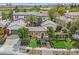 Aerial view of a luxury home with lush landscaping, a circular driveway, and an attached garage at 104 N Royal Ascot Dr, Las Vegas, NV 89144