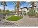 Expansive backyard with lush landscaping, synthetic grass, and mature trees at 104 N Royal Ascot Dr, Las Vegas, NV 89144