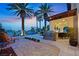 Inviting backyard featuring a built-in barbecue, seating area, and lush landscaping at 104 N Royal Ascot Dr, Las Vegas, NV 89144