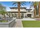 Beautiful home with a manicured lawn, palm trees and refreshing swimming pool at 104 N Royal Ascot Dr, Las Vegas, NV 89144