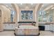 Elegant bathroom with a soaking tub, tiled walls, arched doorways, and decorative lighting at 104 N Royal Ascot Dr, Las Vegas, NV 89144