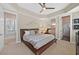 Bedroom with neutral walls, a ceiling fan, and a bed with dark wooden frame at 104 N Royal Ascot Dr, Las Vegas, NV 89144