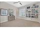 Neutral bedroom with a ceiling fan, built-in shelves, and console table at 104 N Royal Ascot Dr, Las Vegas, NV 89144