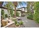 Beautiful courtyard with a central palm tree, stone accents, seating area, and access to the main house at 104 N Royal Ascot Dr, Las Vegas, NV 89144