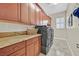 Well-appointed laundry room with granite countertops and modern washer and dryer at 104 N Royal Ascot Dr, Las Vegas, NV 89144