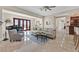 Open-concept living room with piano, comfortable seating, and access to the outdoor patio through French doors at 104 N Royal Ascot Dr, Las Vegas, NV 89144
