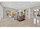 Bright living room with tile floors, neutral furniture, modern decor, and access to an outdoor patio at 104 N Royal Ascot Dr, Las Vegas, NV 89144
