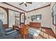 Home office with hardwood floors, a wood desk, and views of the home's stairway and entrance at 104 N Royal Ascot Dr, Las Vegas, NV 89144
