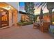 Cozy outdoor dining area with a table and chairs, set amidst lush landscaping at 104 N Royal Ascot Dr, Las Vegas, NV 89144