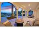 A covered patio provides a comfortable outdoor living space with a fire pit, seating area, and views of the pool at 104 N Royal Ascot Dr, Las Vegas, NV 89144